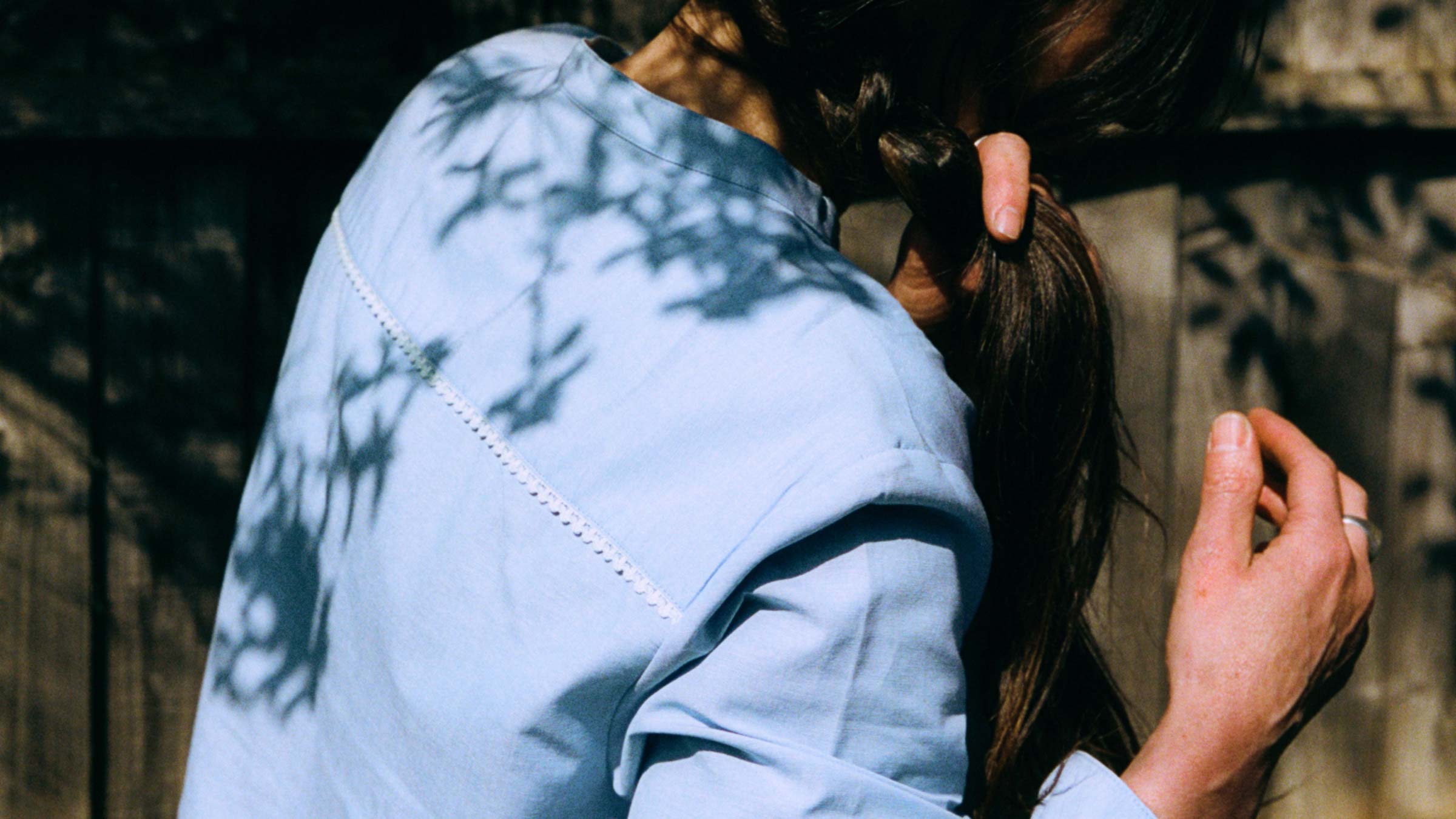 Marie Blouse in pale blue recycled cotton, dappled in sunlight — last chance sustainable womenswear by Saywood, made in England
