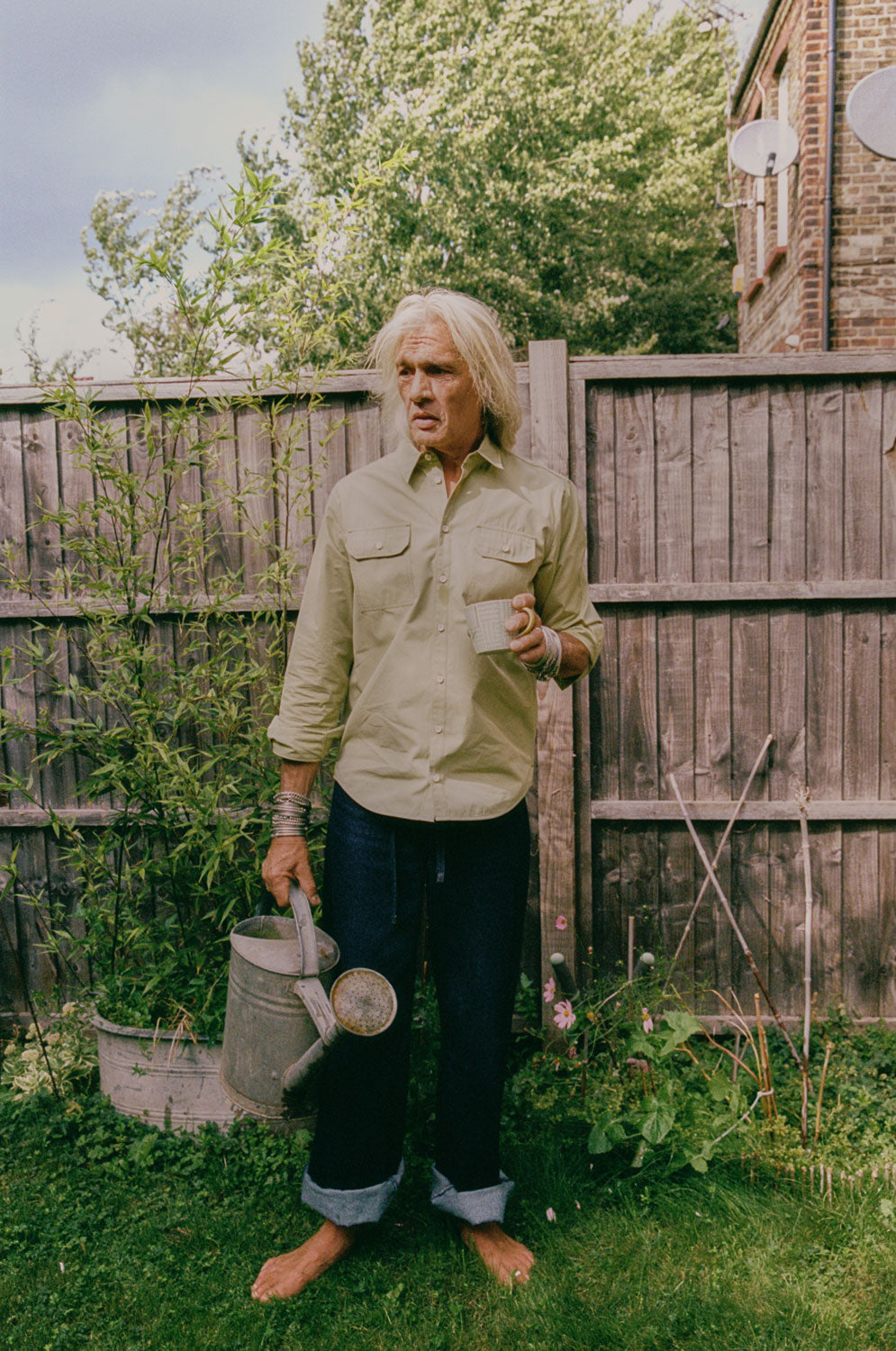 Eddy men's limited edition utility shirt in khaki cotton with patch pockets, handmade in East London by Saywood. Worn with dark indigo jeans.