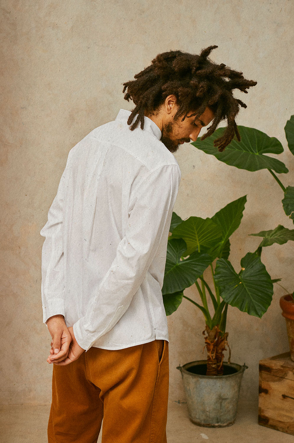 Back detail of Eddy men's classic white shirt in cotton bamboo, relaxed fit, made in London by Saywood. Worn with tobacco trousers.