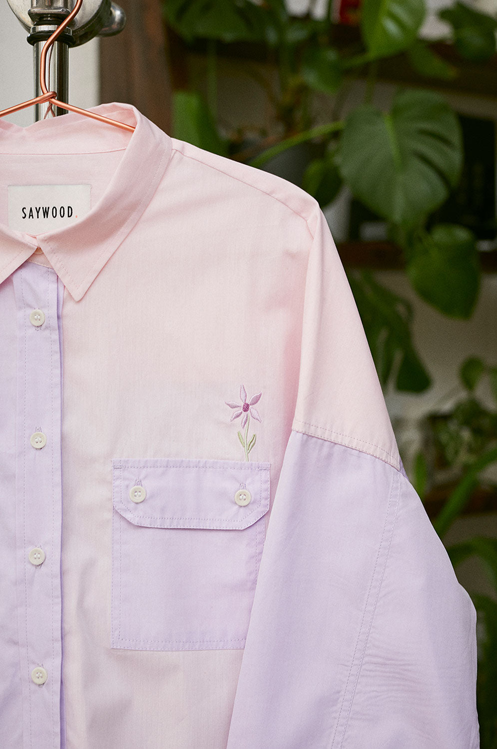 Close up of embroidered flower on the Jules Utility Shirt colourblocked in pink lilac cotton, by Saywood