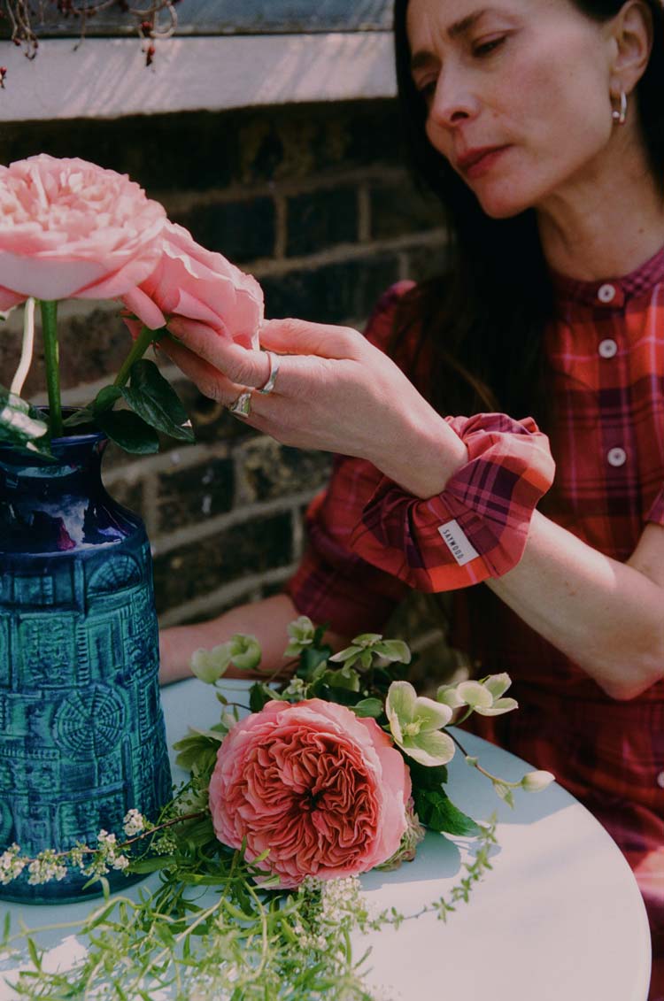 Saywood red tartan scrunchie worn at the wrist, paired with the red tartan Rosa Dress — sustainable accessories made in England by Saywood