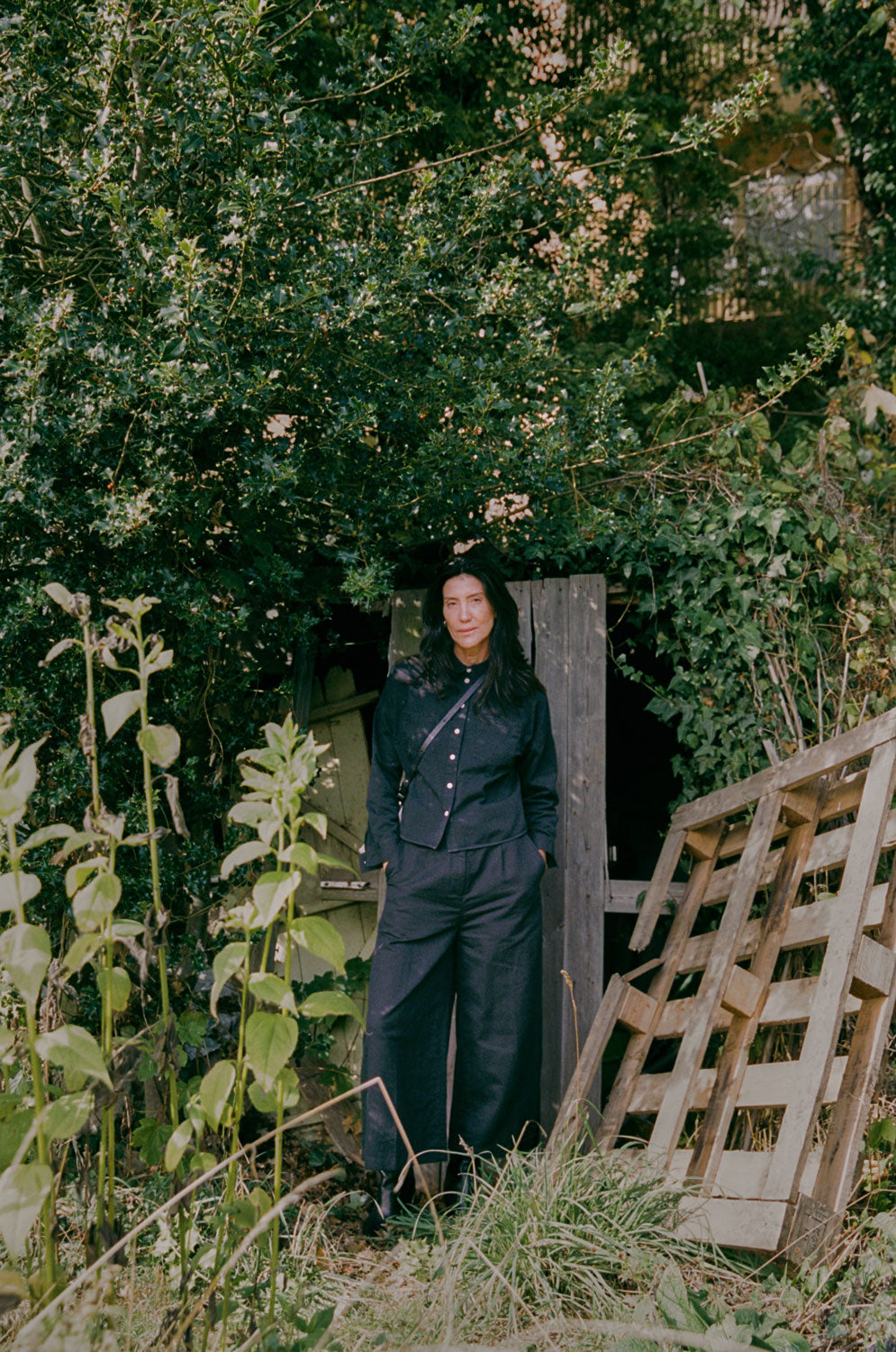 Styling inspiration: Lela black Japanese denim shirt paired with wide leg trousers, outdoor lifestyle shot by Saywood