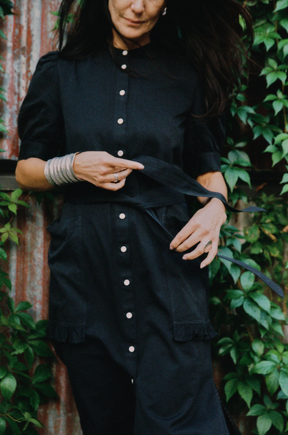 Detail of Rosa shirtdress in black Japanese denim showing puff sleeves and ruffle pocket trim by Saywood