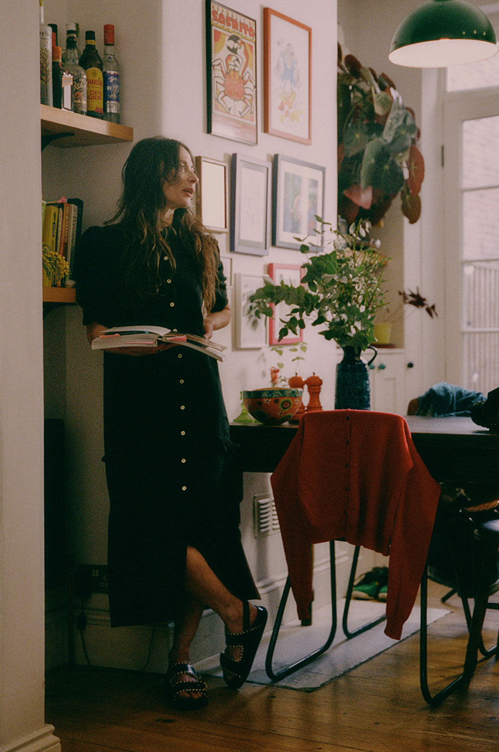 Lifestyle shot: Rosa black Japanese denim shirtdress styled with chunky sandals, made in London by Saywood