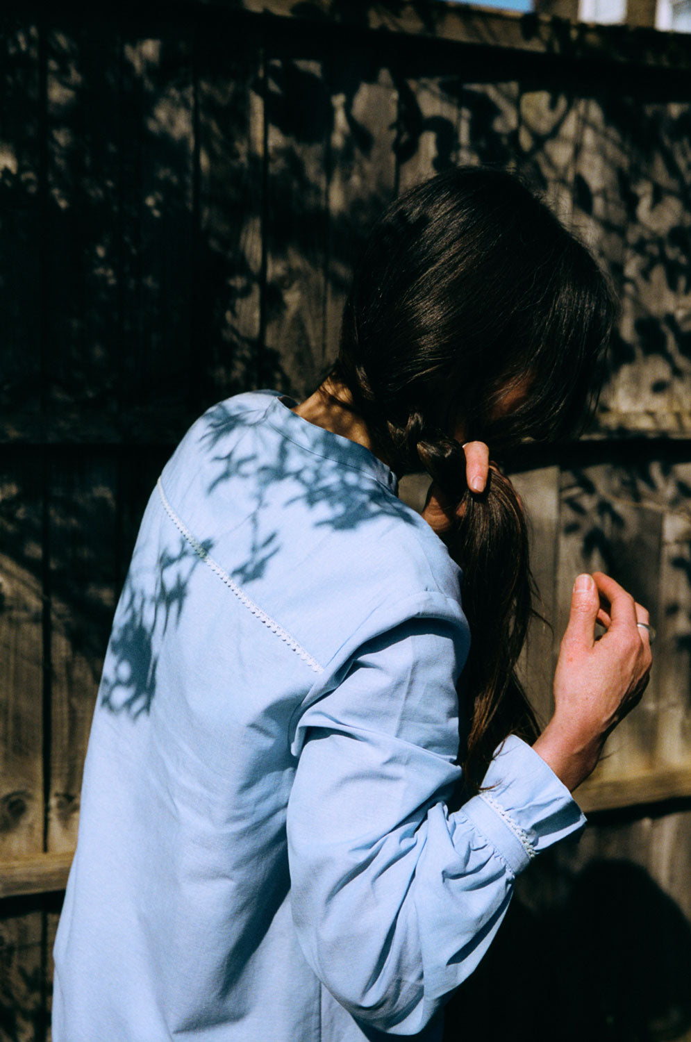 Detail view of Marie blouse showing lace trim at back neck yoke and gathered frill cuffs, recycled cotton by Saywood