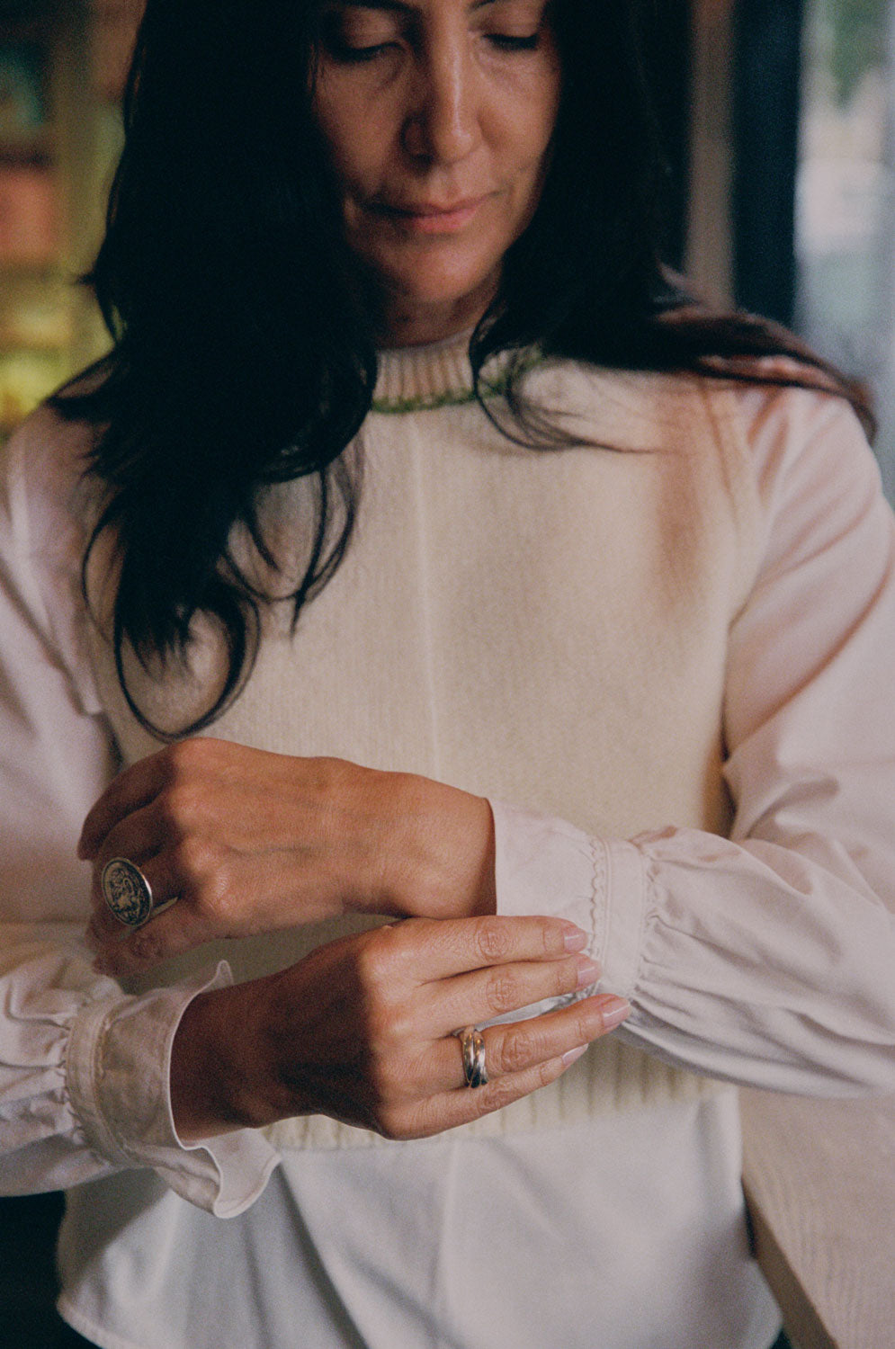 Gathered frill cuff detail of the Marie Blouse in white recycled cotton, styled with the Ada Vest in cream. Made in Britain by Saywood.