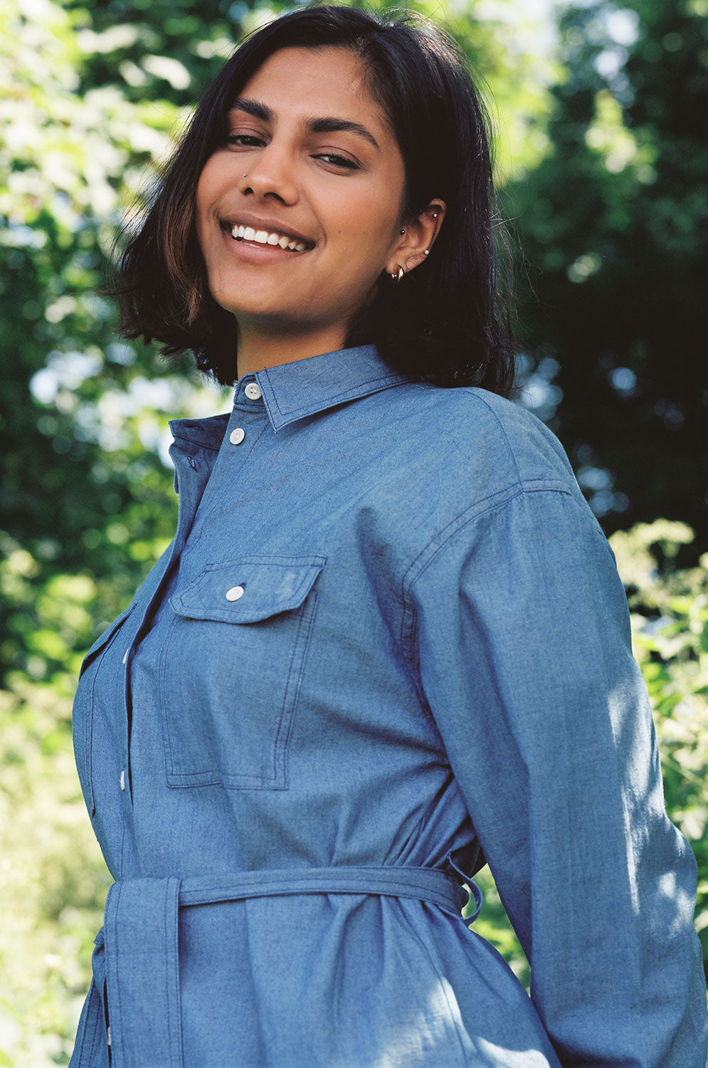 Detail view of Zadie Japanese denim shirt showing utility patch pockets and topstitch detailing by Saywood