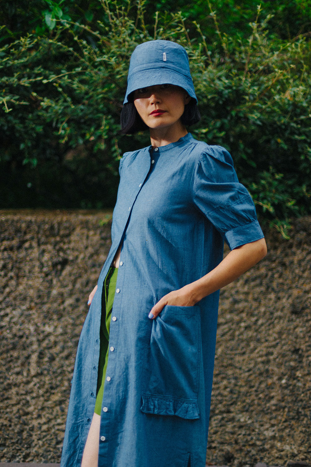 Rosa Japanese denim shirtdress worn open over Bessie green shorts with bucket hat