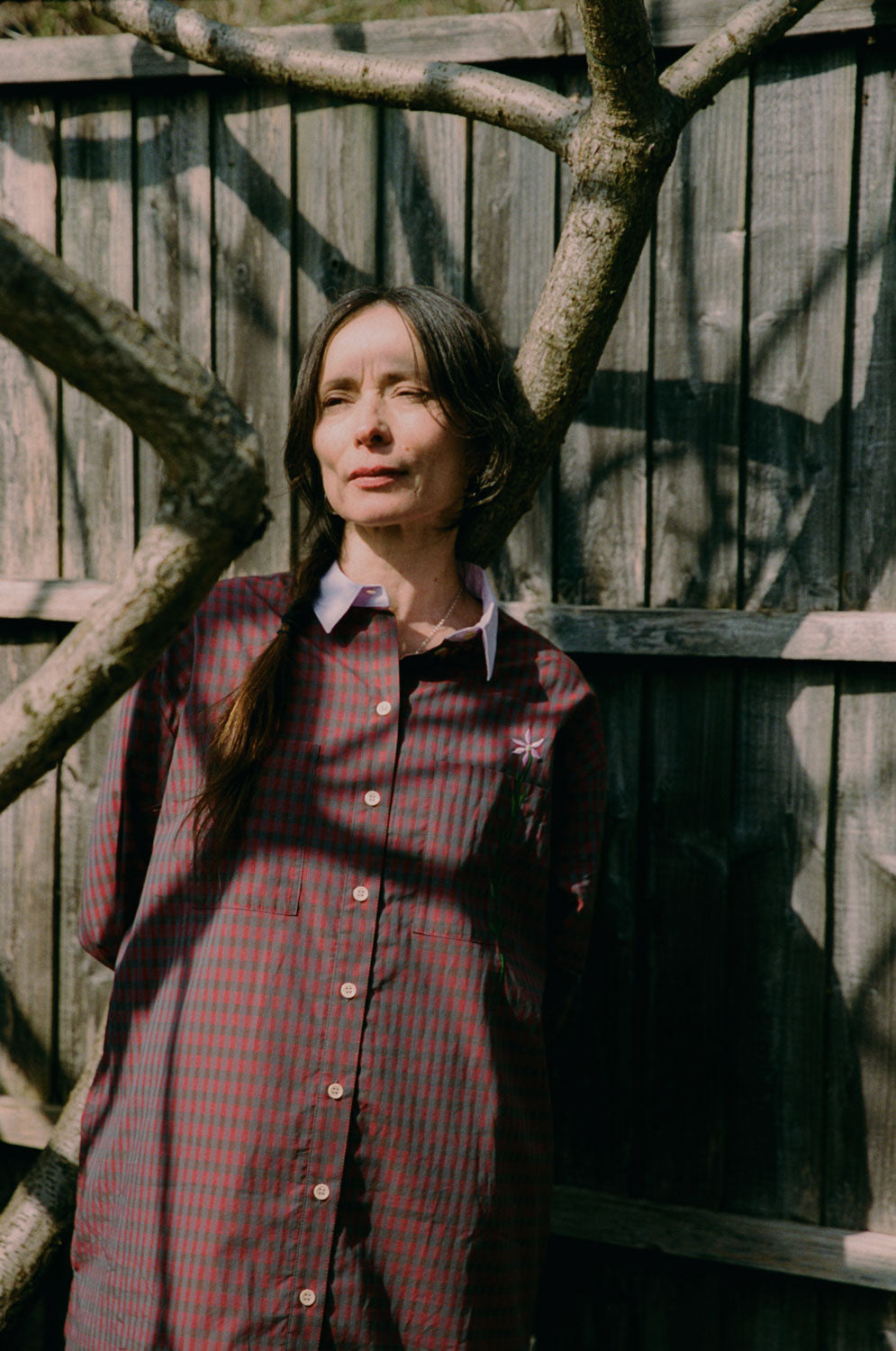 Etta red check shirtdress detail shot showing embroidered flower pocket and lilac collar, deadstock cotton by Saywood