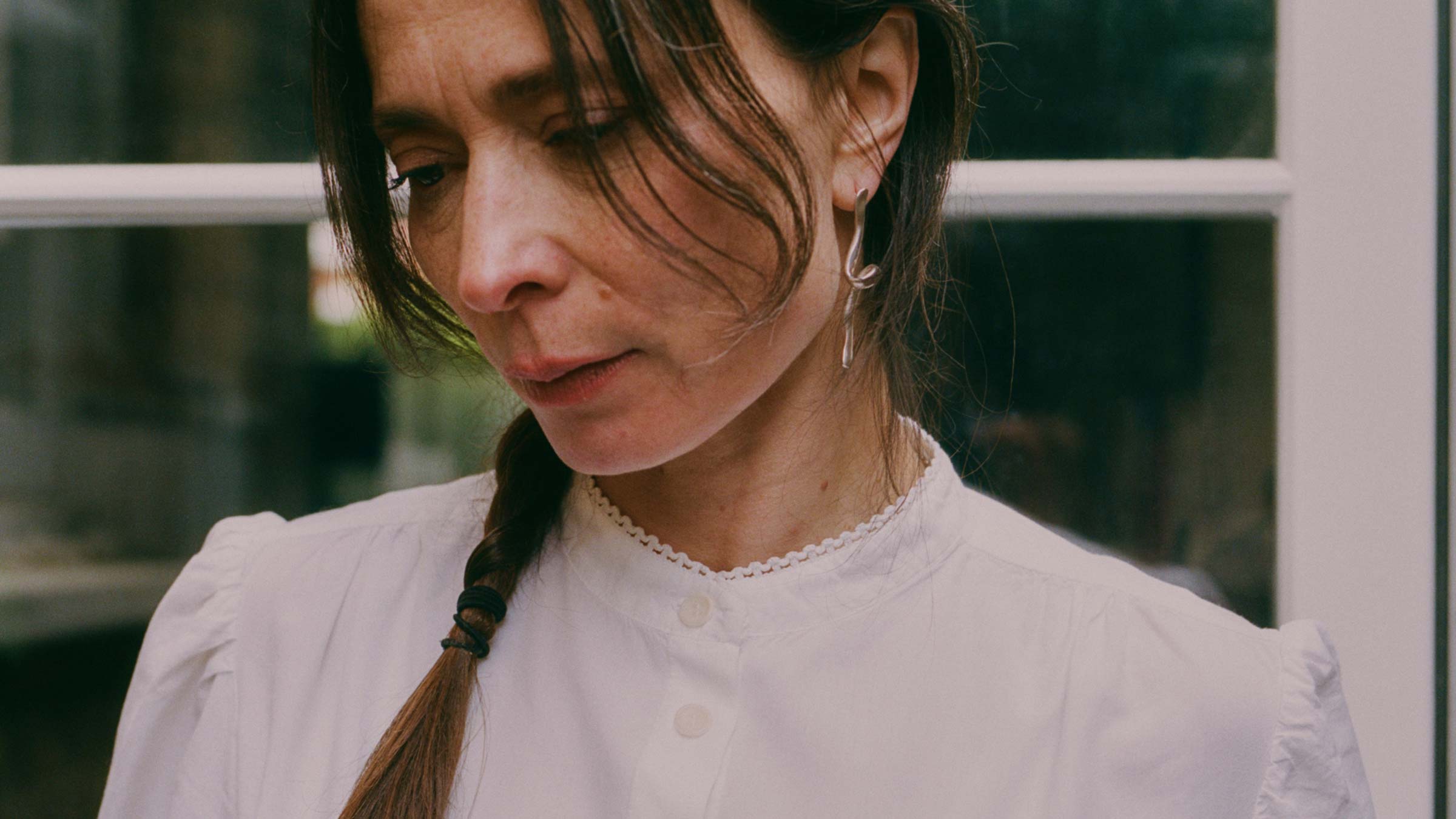Joni Puff Sleeve Blouse in white, worn with delicate gold jewellery — sustainable womenswear made in England by Saywood