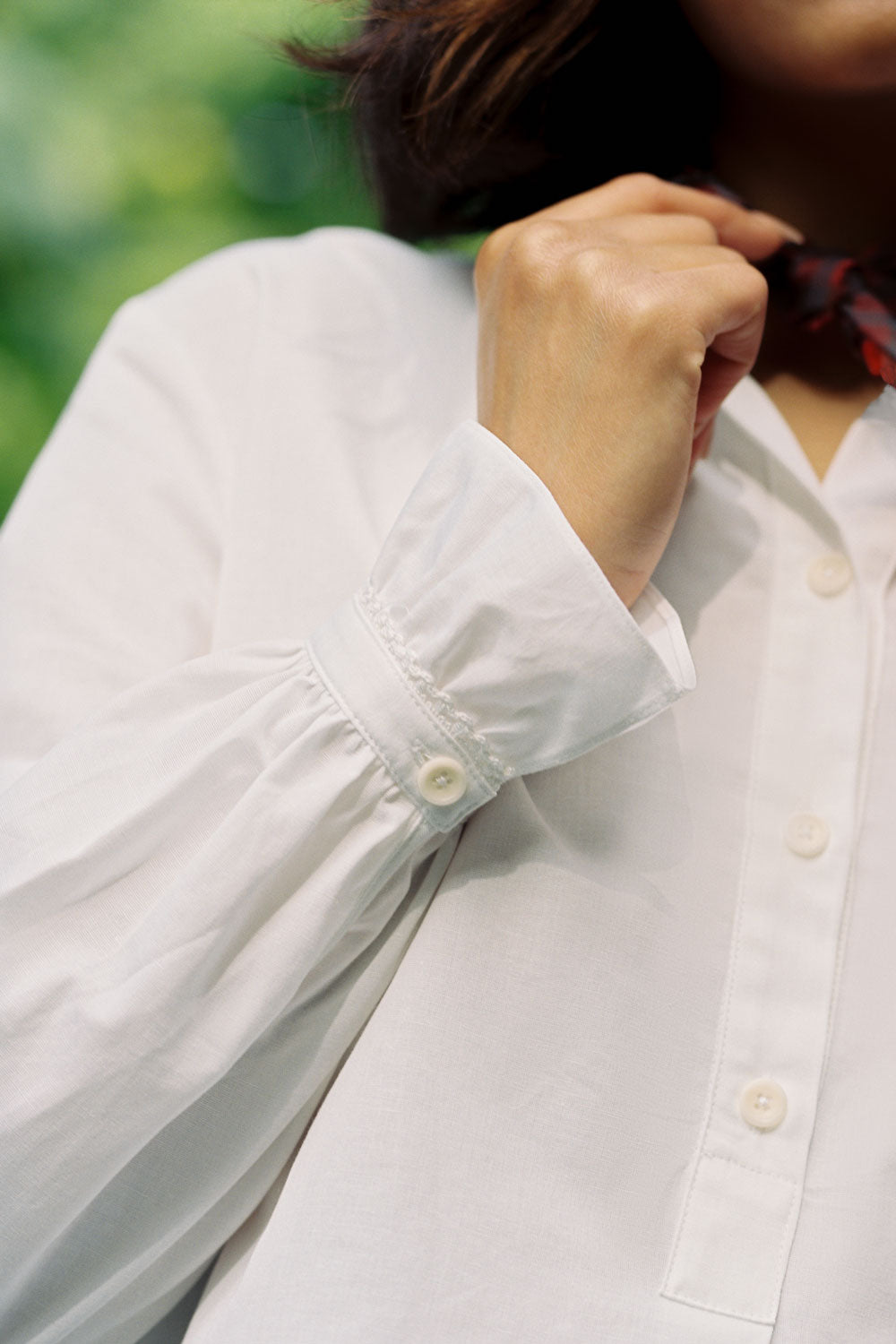 Close-up of Marie blouse lace-trimmed gathered cuff detail, white recycled cotton by Saywood