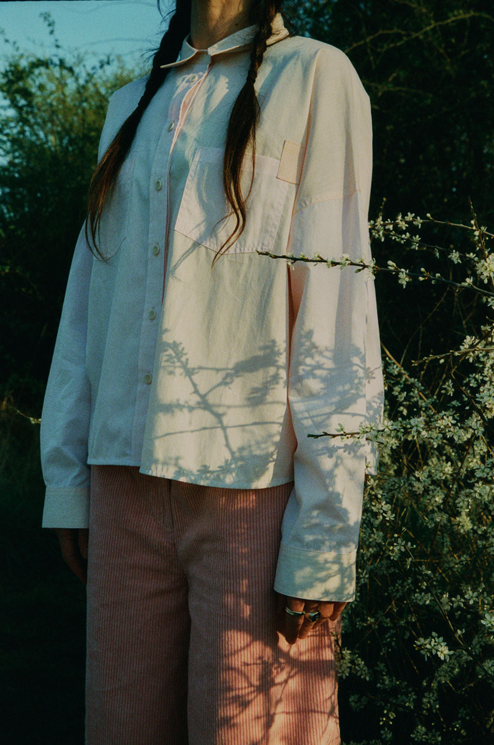 Close-up of Amelia pink corduroy trousers with Lela pastel shirt, sustainable fashion made in London by Saywood